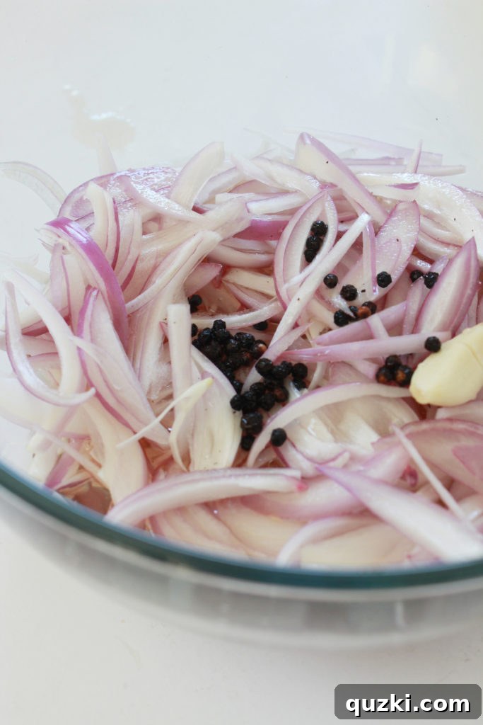 Tangy Shallot Gems 6 Shallots submerged in pickling liquid with a plate weighing them down