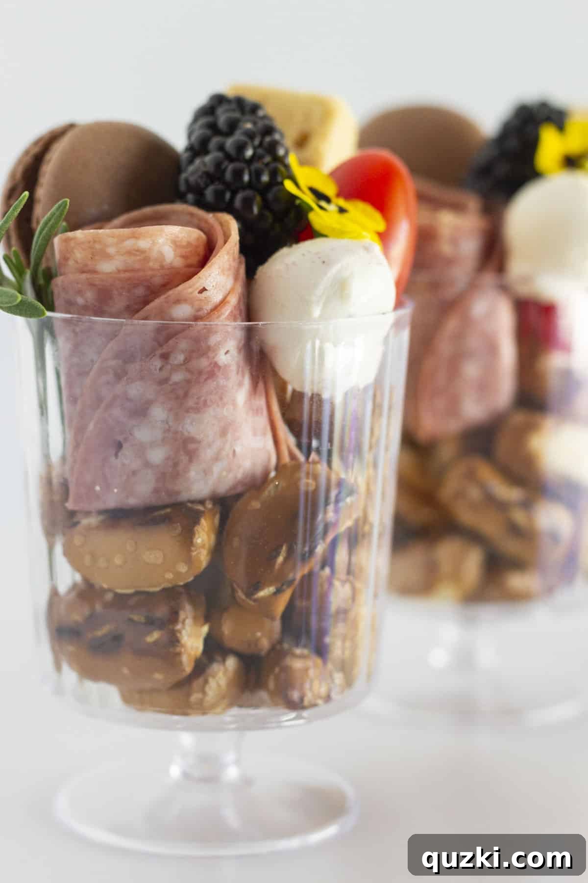 Charcuterie Cups beautifully filled with a variety of small food items, each in a clear cup.