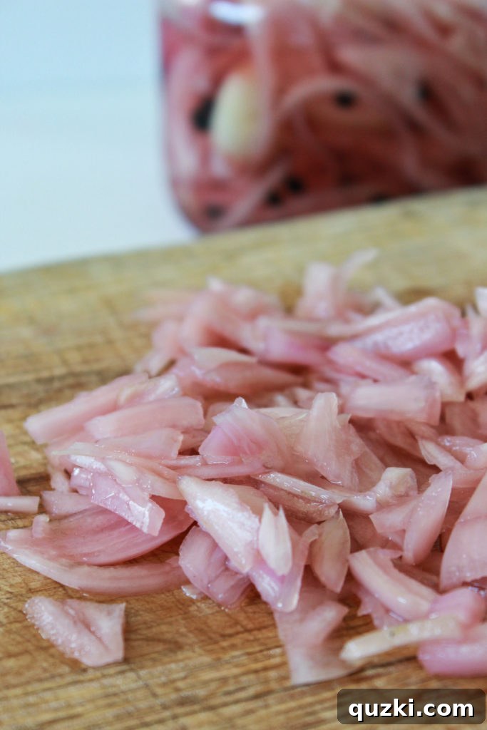 Chopped pickled shallots, ready to add a tangy twist to the cucumber salad.