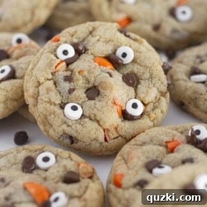 A tray of Halloween Chocolate Chip Cookies adorned with festive orange candies and edible googly eyes, ready for a spooky celebration.