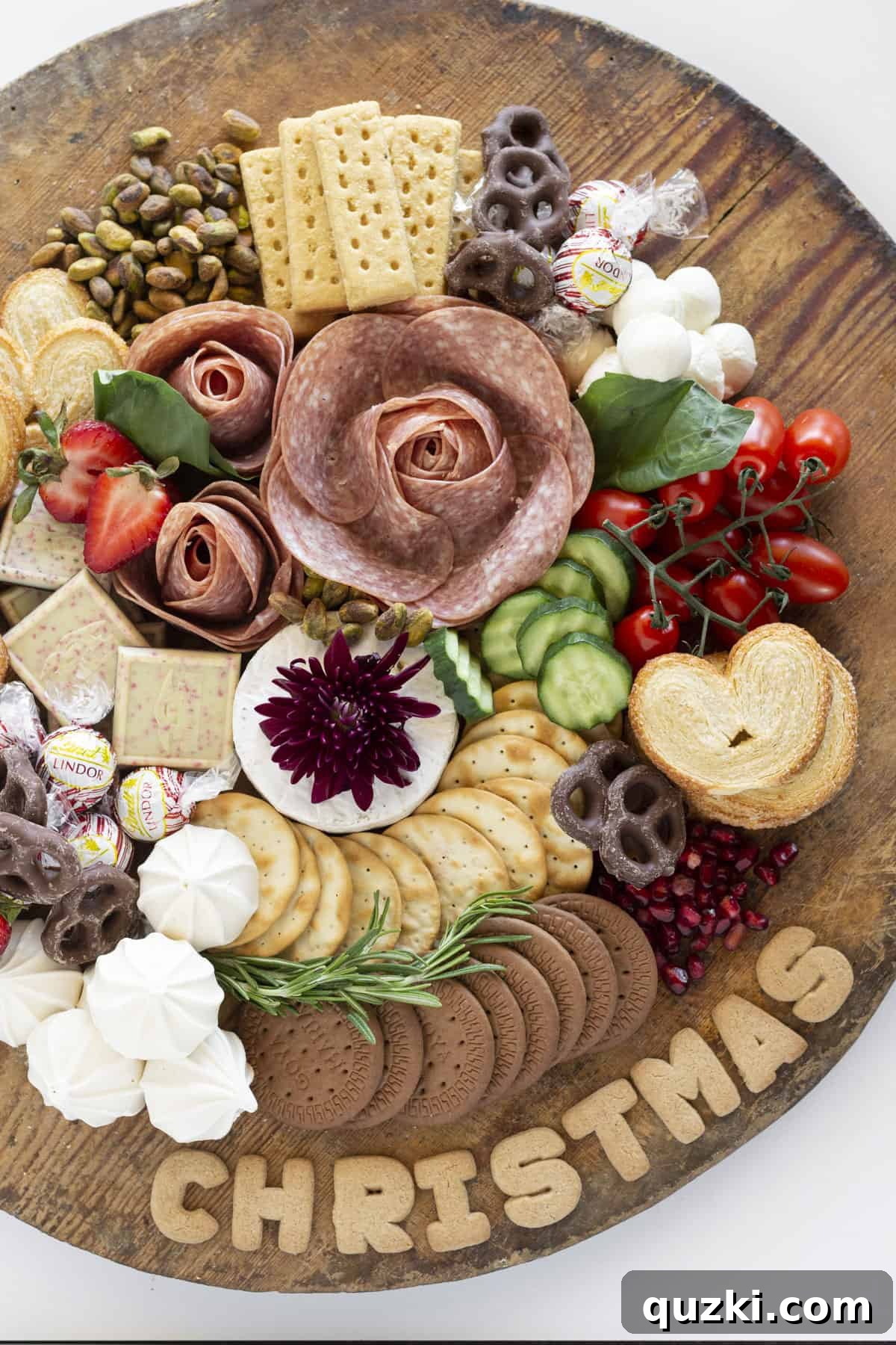 Crafting the Ultimate Christmas Charcuterie Board 2 A finished Christmas Charcuterie board with salami roses, cheese, fruits, and crackers arranged festively.