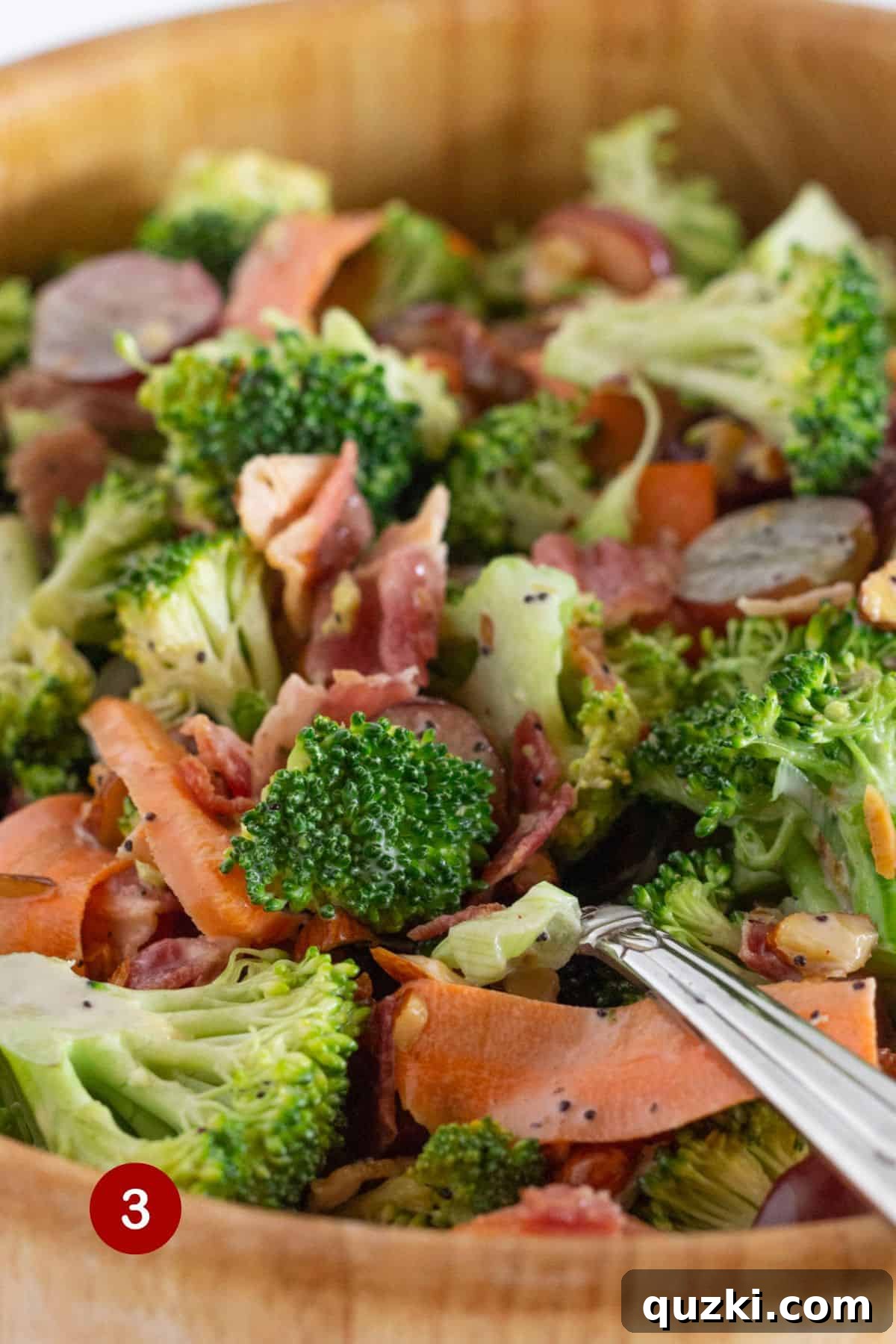 Smoky Bacon Broccoli Crunch Salad 5 The final step of making broccoli crunch salad, showing a close-up of the salad being stirred to ensure all ingredients are coated in the creamy dressing.