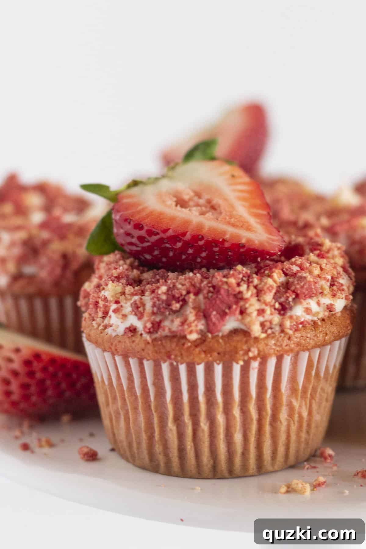 Sweet Strawberry Crunch Cupcakes 8 A strawberry crunch cupcake with vanilla frosting and fresh strawberries.
