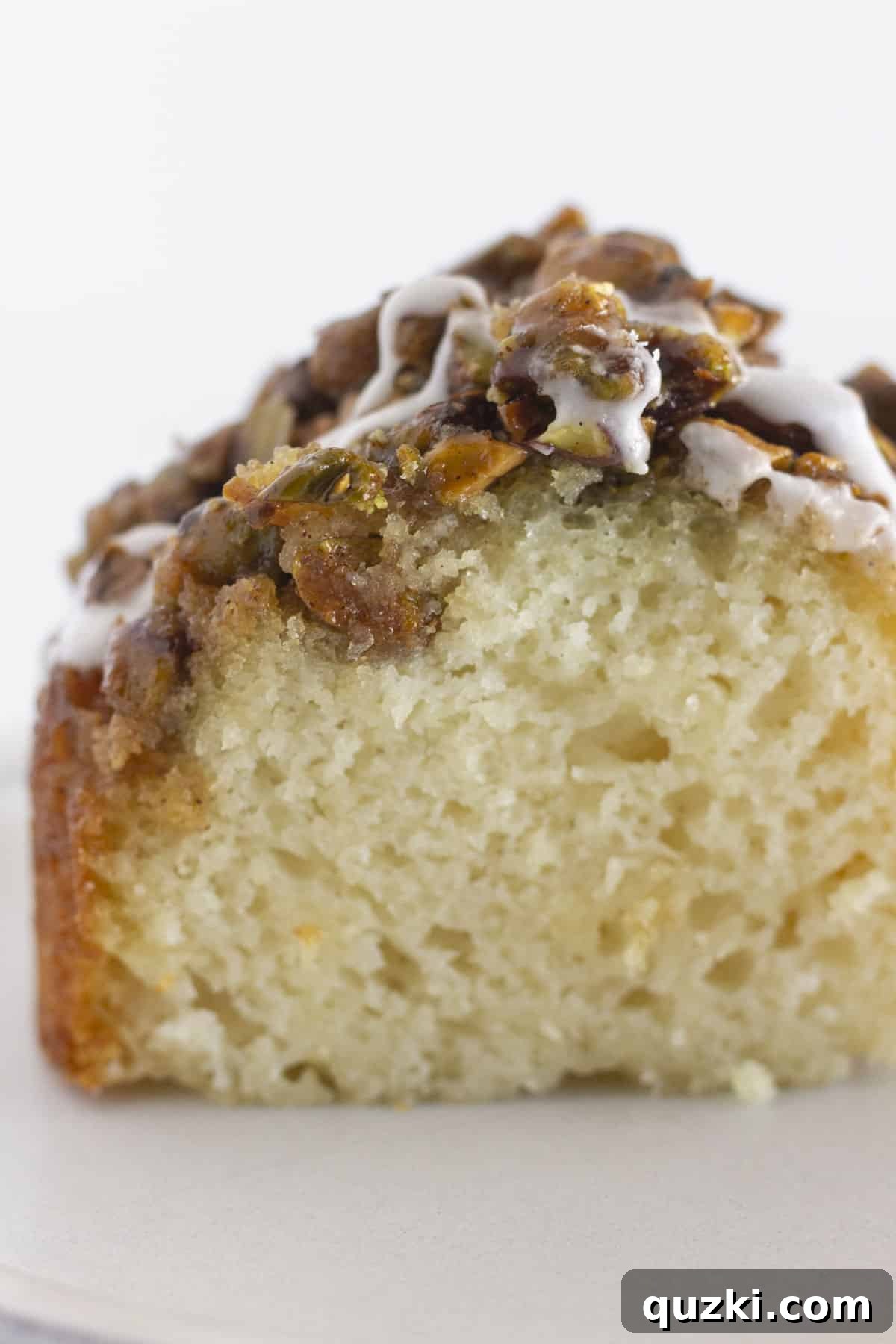 Emerald Pistachio Bundt Flip 7 A perfectly sliced piece of pistachio upside down cake, showing the moist cake and the rich topping.
