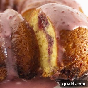 A slice of Raspberry Lemonade Bundt Cake with glaze, ready to be served.