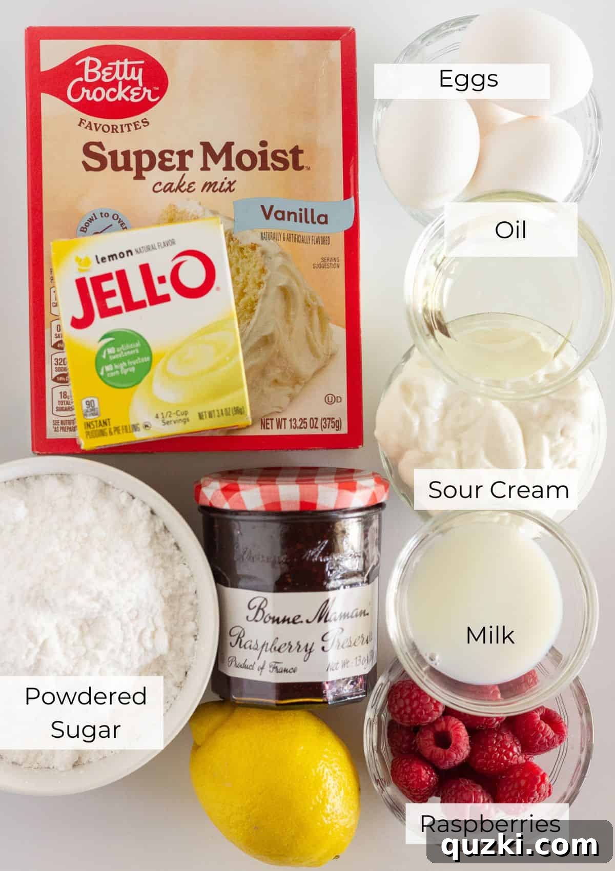 Sunny Raspberry Lemon Bundt Cake 3 The essential ingredients laid out for making a Raspberry Lemonade Bundt Cake, including cake mix, pudding mix, eggs, sour cream, and fresh raspberries.