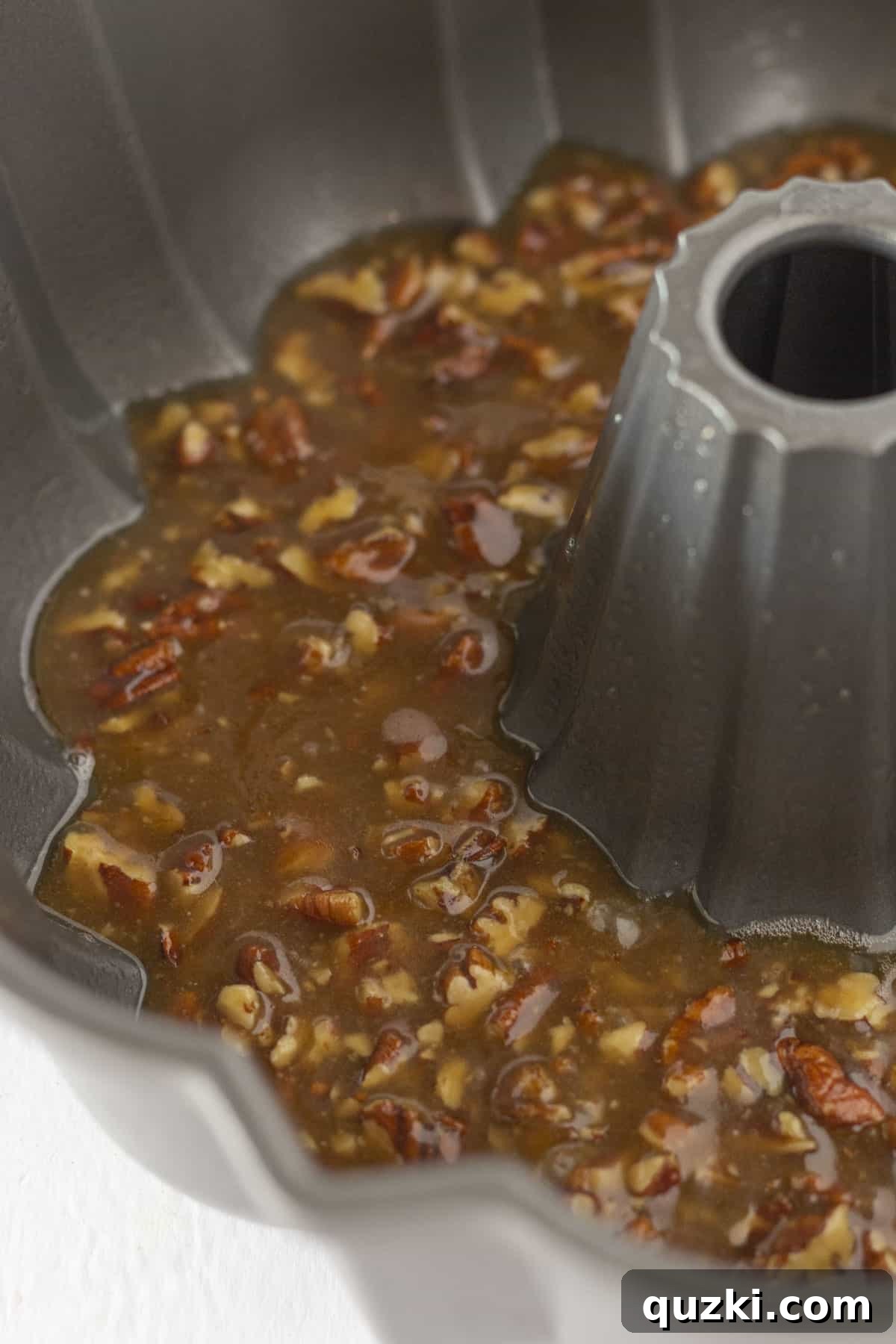 A nonstick bundt pan with pecan topping, ready for the batter.