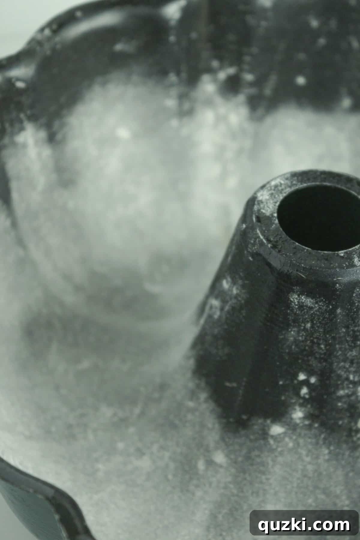 A bundt pan properly sprayed with nonstick spray and dusted with flour, showing an even coating.