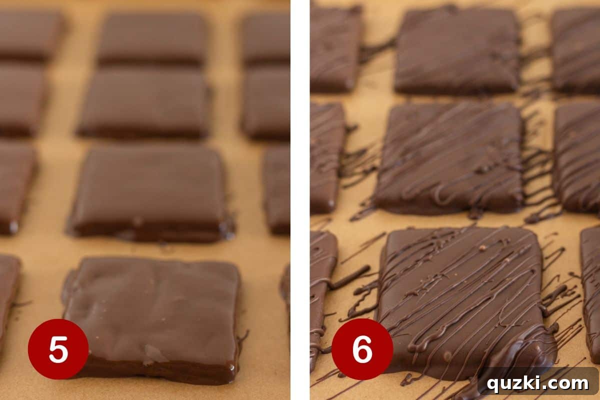 Finished chocolate covered graham crackers placed on a parchment-covered baking sheet, ready to chill.