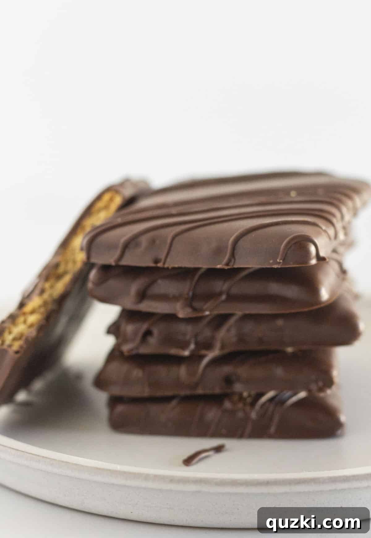 Stacked graham crackers covered in various types of chocolate with different toppings.