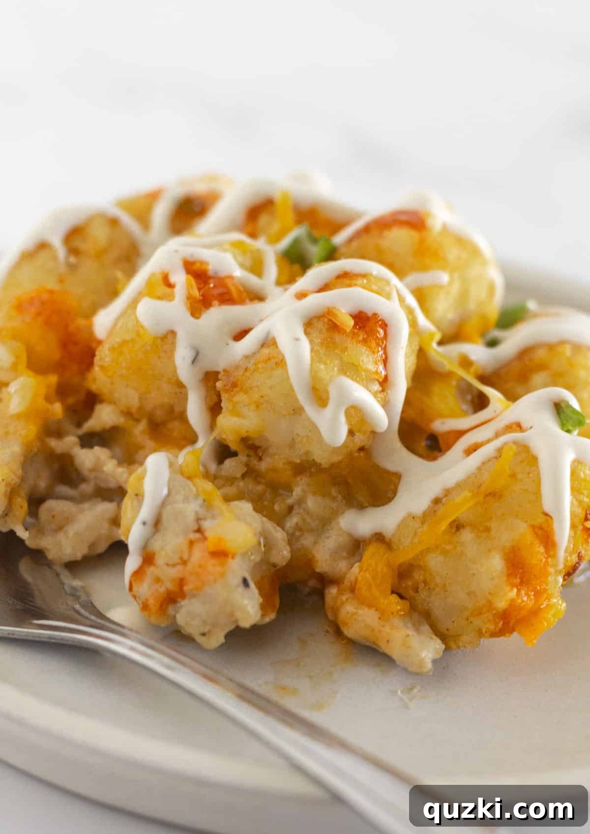 Ultimate Buffalo Chicken Tater Tot Casserole 6 A generous serving of buffalo chicken tater tot casserole, ready to enjoy.
