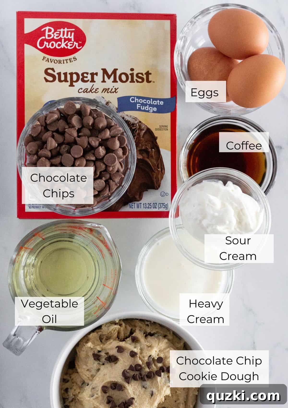 Ultimate Chocolate Chip Cookie Dough Cake 3 The ingredients needed to make cookie dough cake laid out on a table.