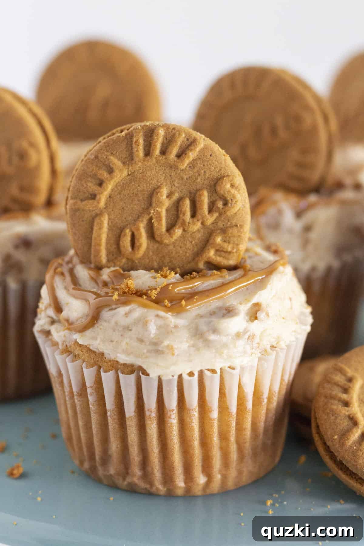 Biscoff cupcakes on a blue cake plate, beautifully decorated and ready to enjoy.