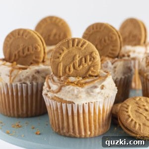 A half dozen Biscoff cupcakes on a blue cake plate.