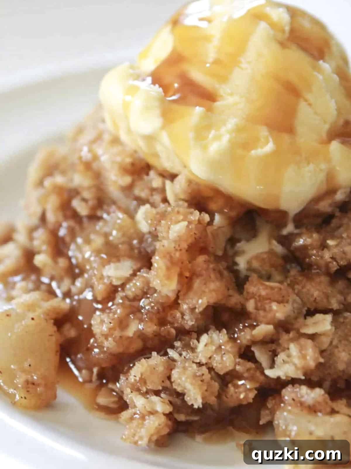 Golden Skillet Apple Crisp 4 Close-up of skillet apple crisp with vanilla ice cream and caramel sauce, ready to be served.