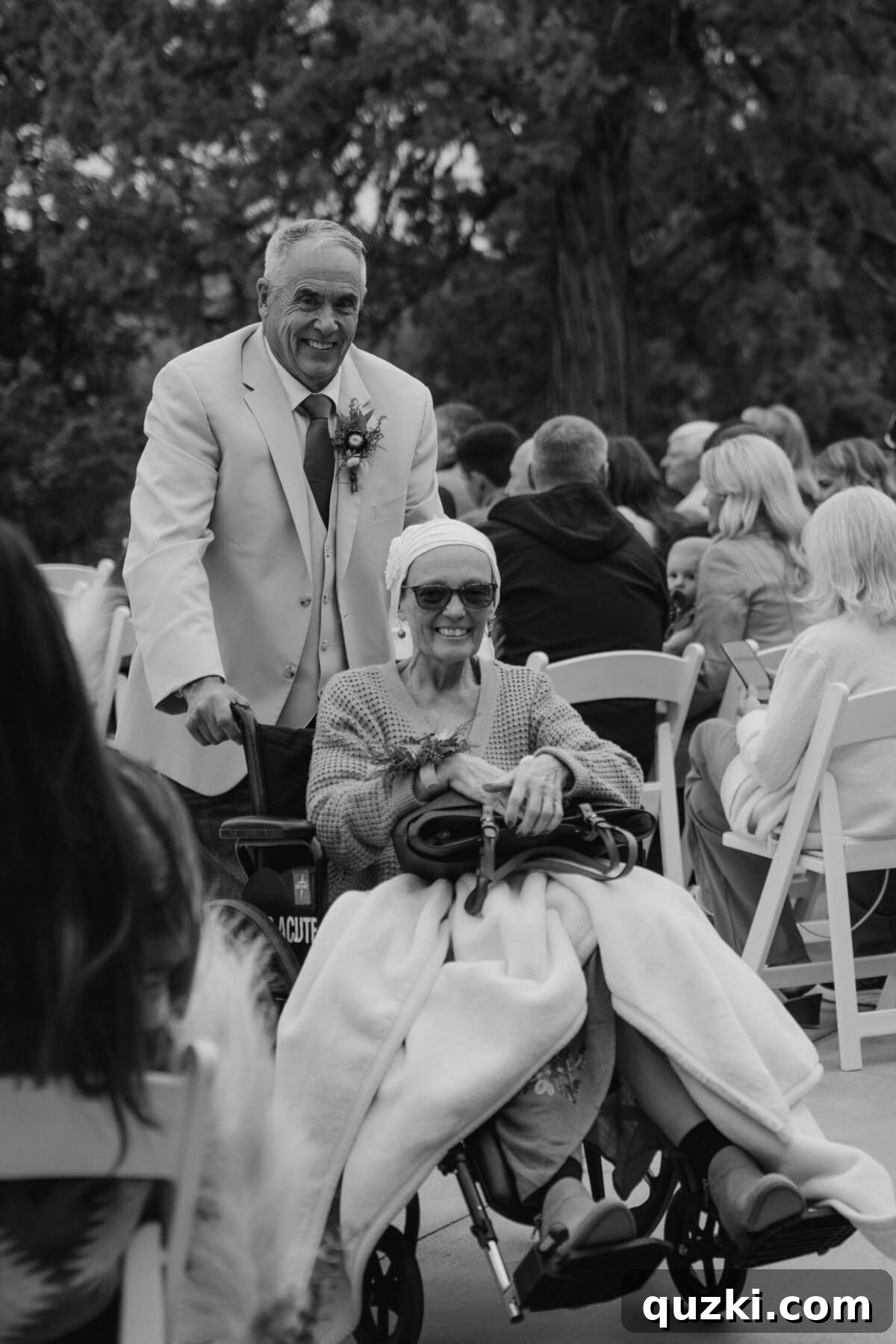 Jordan's parents, beaming with pride and happiness, watching their son's wedding ceremony from the front row.