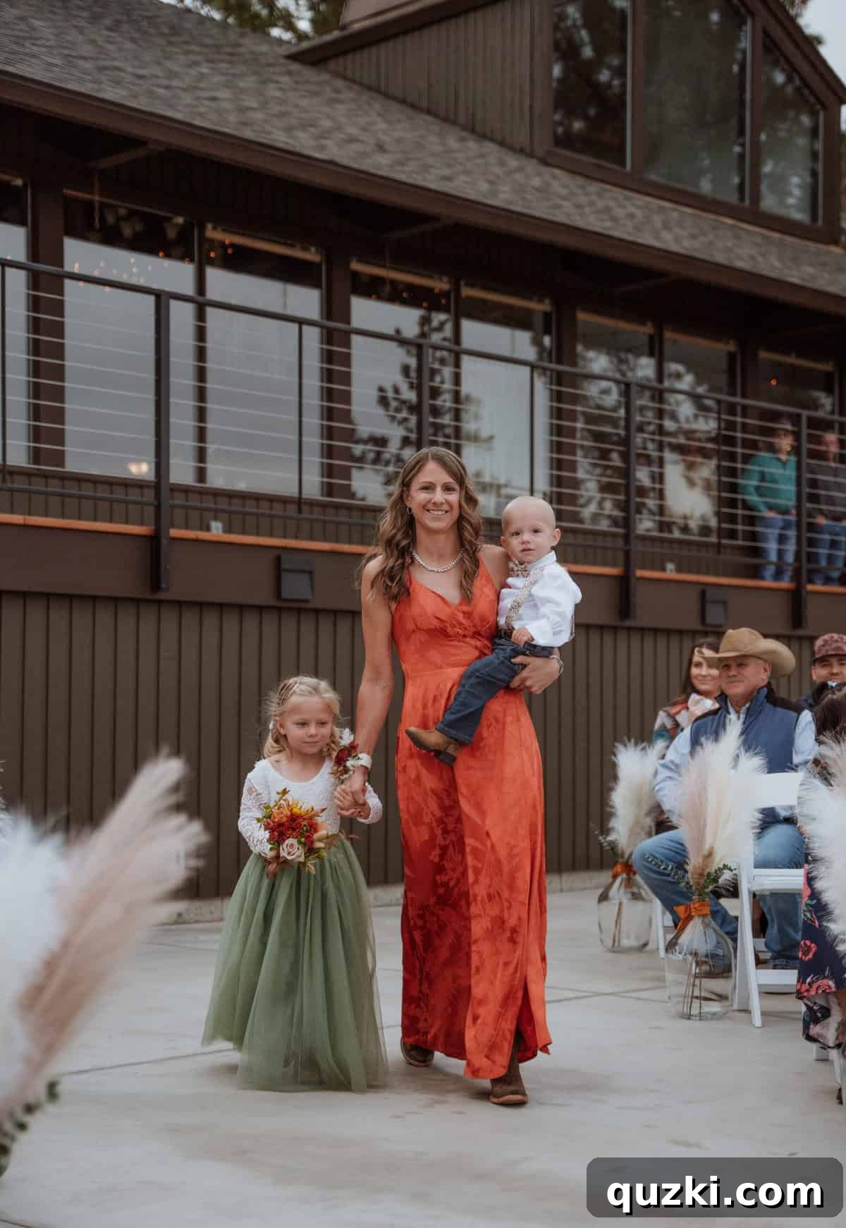 The adorable flower girl, Louise, and ring bearer, Jack, gracefully making their way down the wedding aisle, adding a sweet touch to the ceremony.