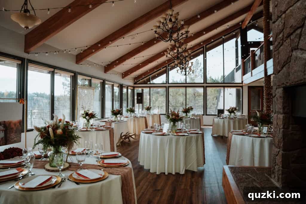 An elegantly decorated wedding reception table, featuring ivory tablecloths, floral centerpieces, gold accents, and personalized place settings with burnt orange napkins.