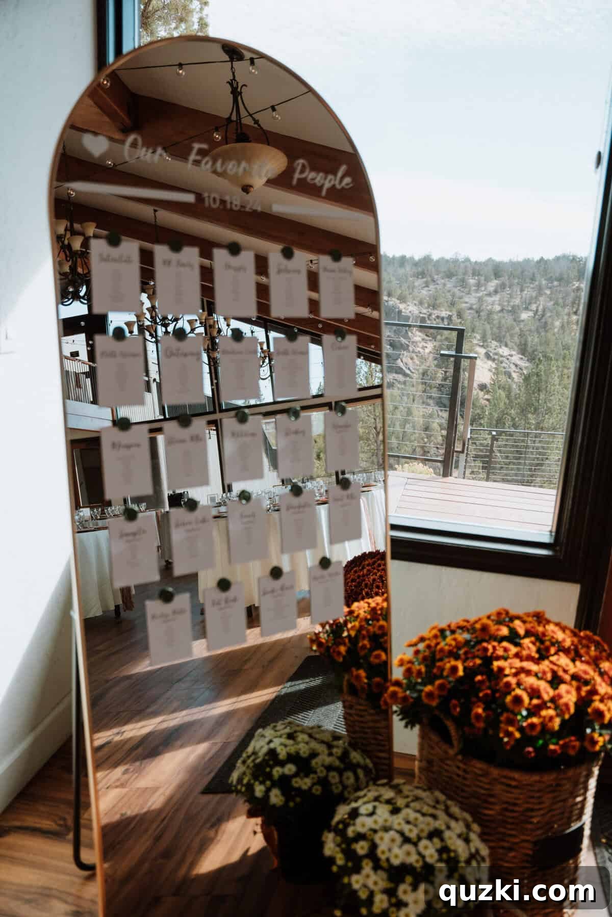 A stunning gold-framed mirror displaying the wedding seating arrangements, personalized by the bride, serving as a beautiful and functional decor piece.