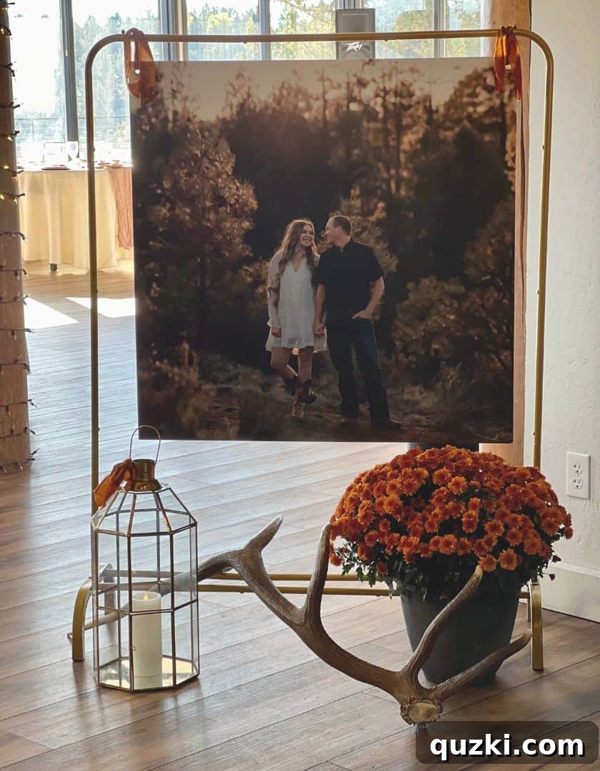 Elegant wedding decorations featuring large engagement photos displayed on gold garment racks, accented with velvet ribbon, adding a personalized touch to the venue.