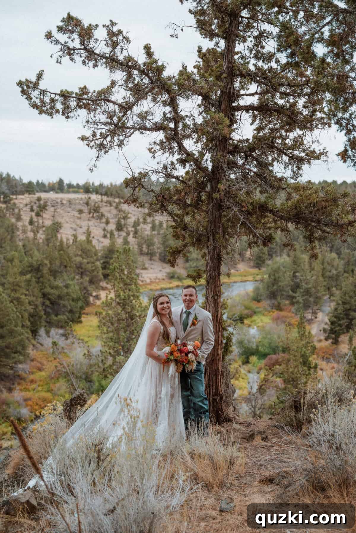 The bride and groom, Taylea and Jordan, sharing a romantic moment together, with the stunning wedding venue and natural landscape visible in the background.