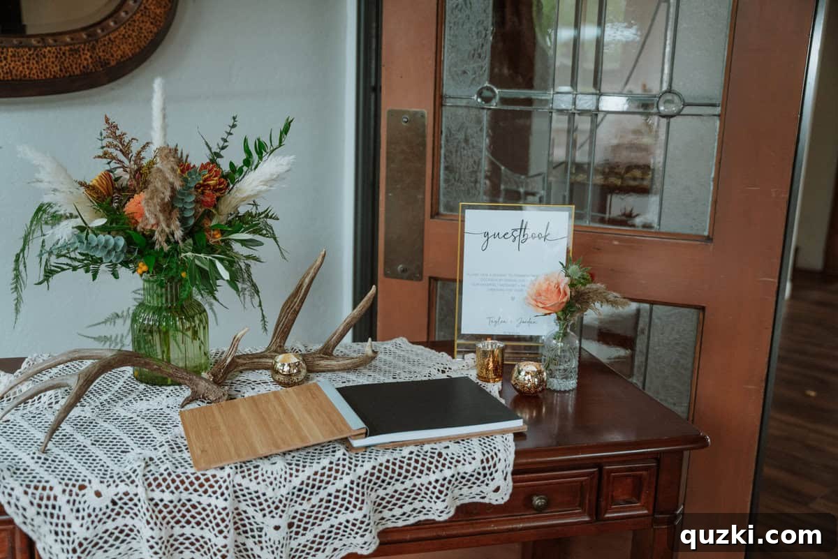A beautifully arranged guest book table featuring a crocheted tablecloth, a thoughtful family heirloom, enhancing the rustic wedding decor.