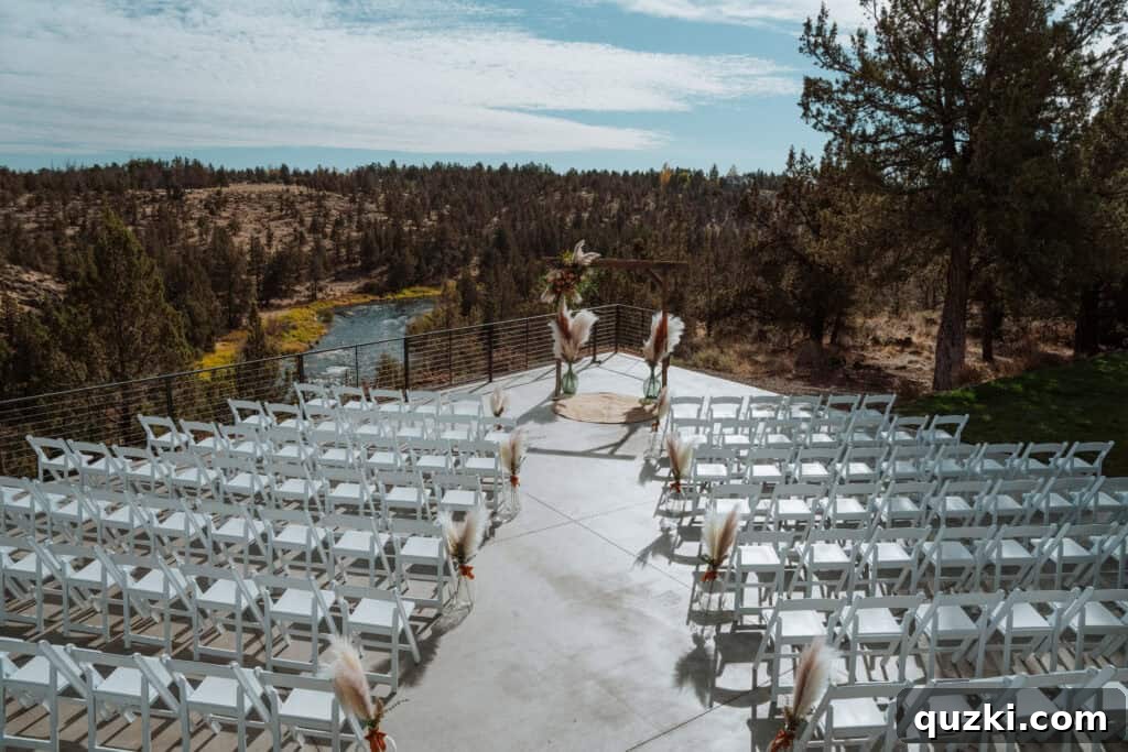The exquisitely decorated outdoor ceremony area at the wedding venue, featuring stunning floral arrangements and boho-chic pampas grass accents overlooking the gorge.