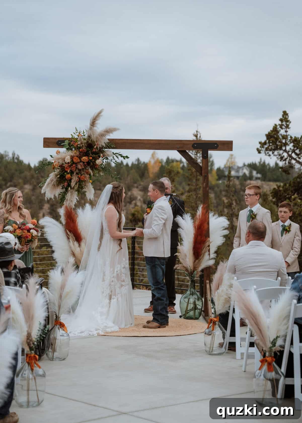 Taylea and Jordan standing at the beautifully decorated altar during their wedding ceremony, exchanging loving glances as they prepare to say their vows.