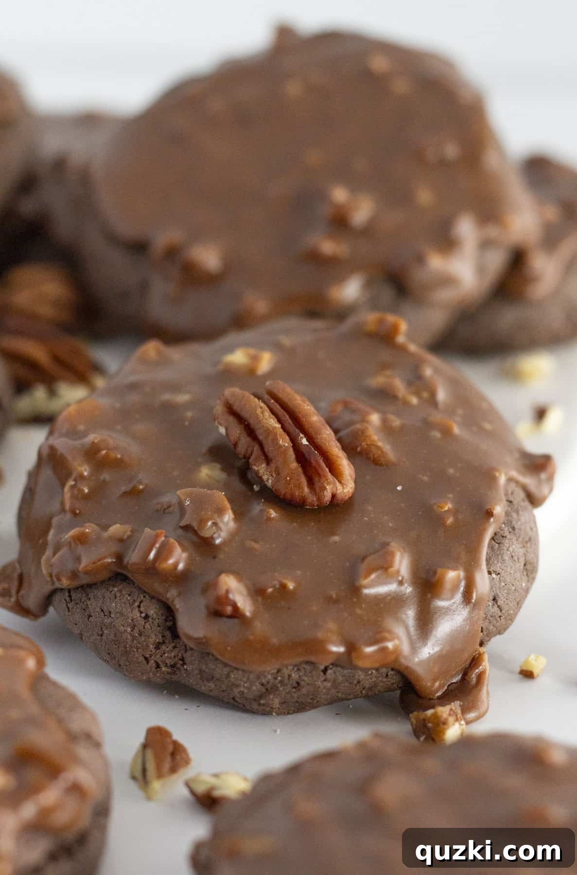 Holiday Cookie Exchange Favorites 4 Decadent Texas Sheet Cake cookies, generously topped with chocolate frosting and a sprinkle of chopped pecans, arranged beautifully for a holiday treat.