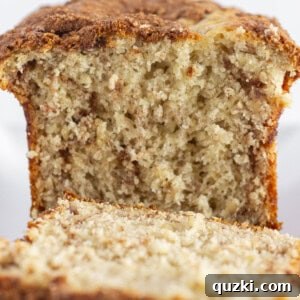 A loaf of cake mix banana bread with a cinnamon swirl baked inside, presented invitingly.