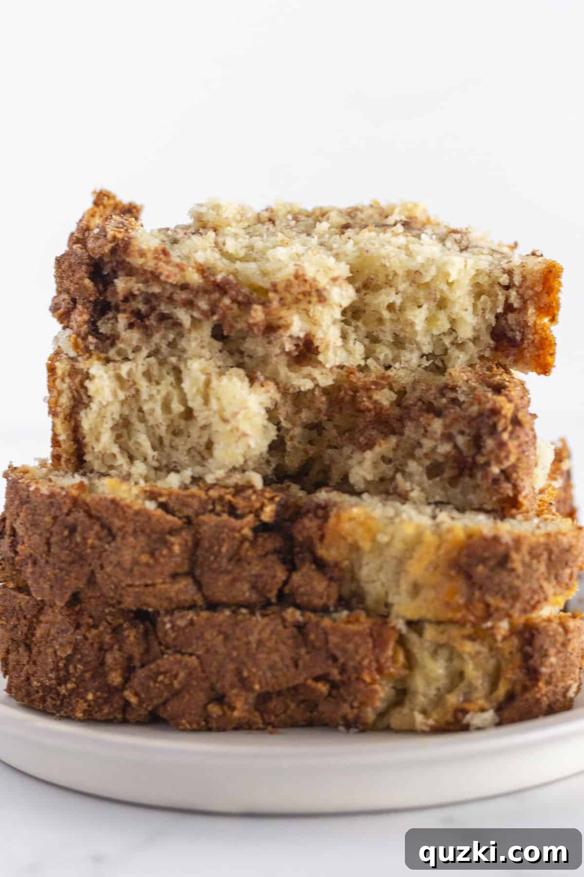 Cake Mix Banana Bread Hack 7 Stacked slices of delicious cake mix banana bread, clearly showing the beautiful and inviting cinnamon swirl in the middle.