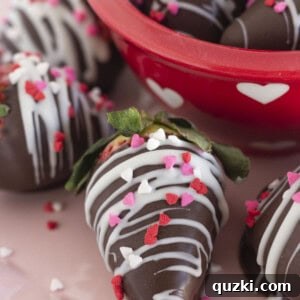 Chocolate dipped Valentine strawberries on a pink plate for serving.