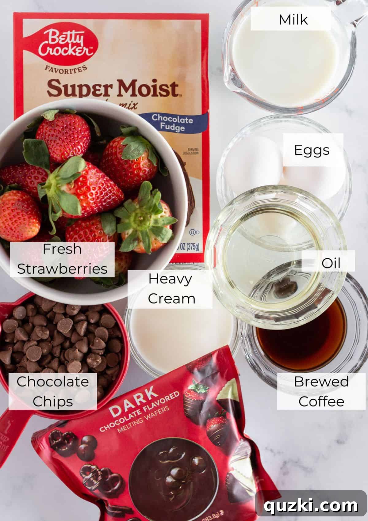 The array of fresh ingredients needed to bake a delicious chocolate covered strawberry cake, neatly laid out.