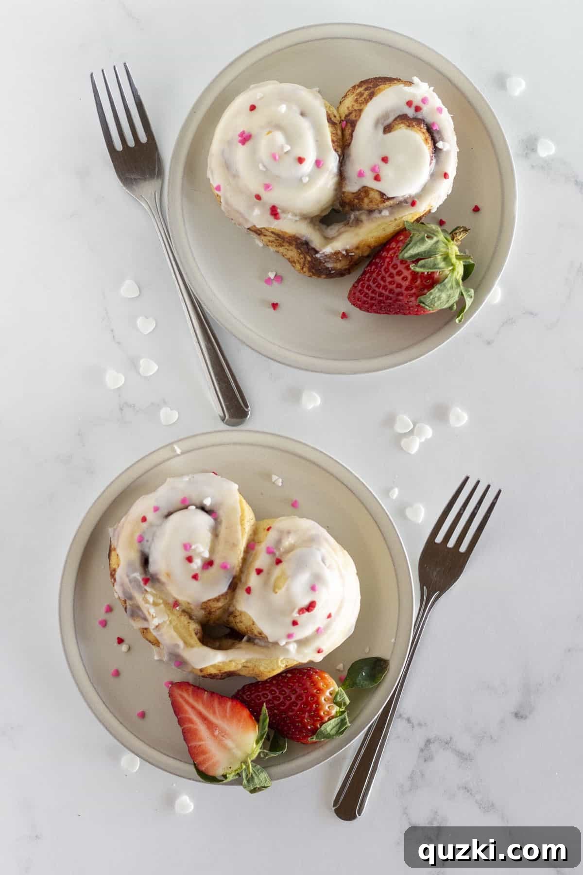 Simple & Sweet Heart Cinnamon Rolls 7 Heart shaped cinnamon rolls served beautifully on plates with fresh strawberries, ready for a special breakfast.