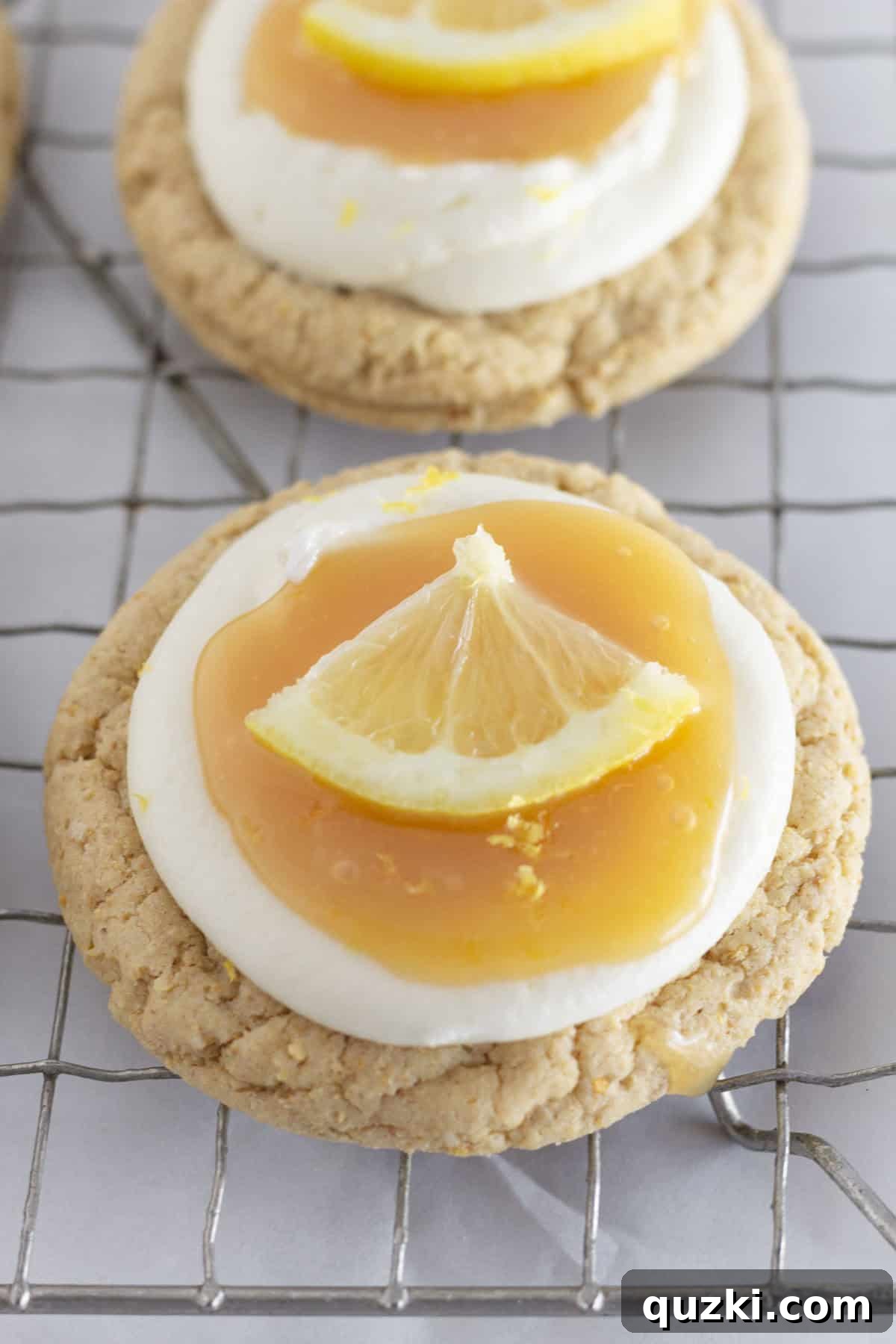Simple Zesty Lemon Cheesecake Cookies 7 Frosted lemon cheesecake cookies cooling on a wire rack, showing off their beautiful toppings.