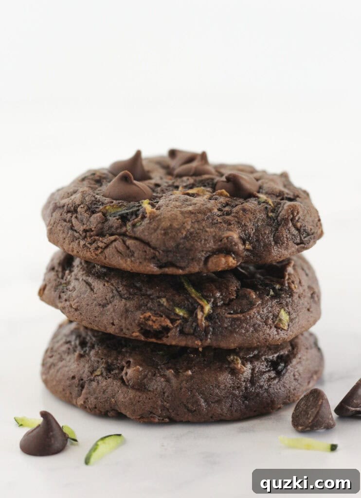 Cake Mix Cookie Magic: Decadent Chocolate Treats 24 Three moist Chocolate Zucchini Sheet Cake Cookies stacked, revealing a hint of the fresh zucchini within.