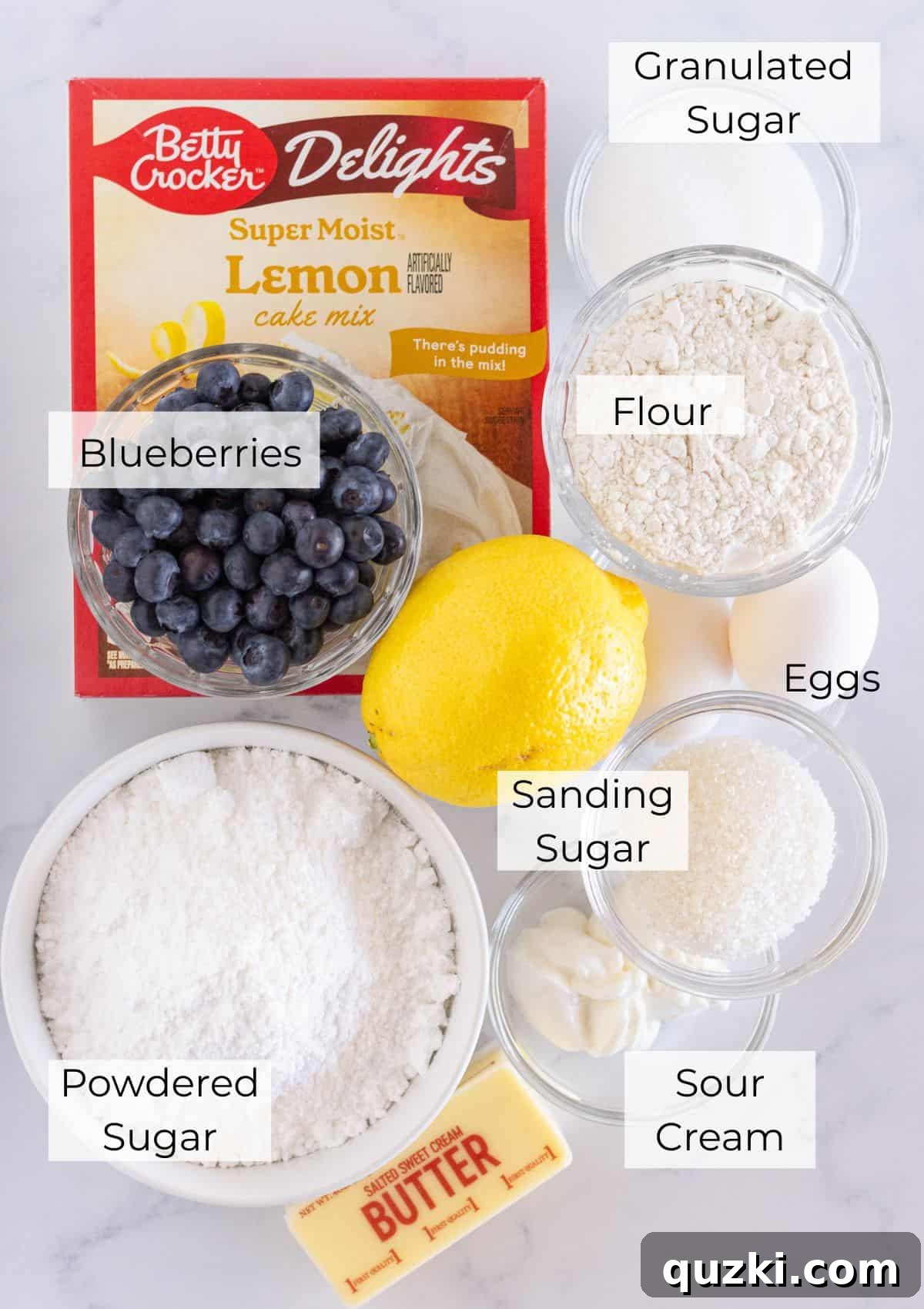The simple ingredients required to bake delicious Lemon Blueberry Cake Mix Cookies, including a lemon cake mix, fresh blueberries, and baking staples.