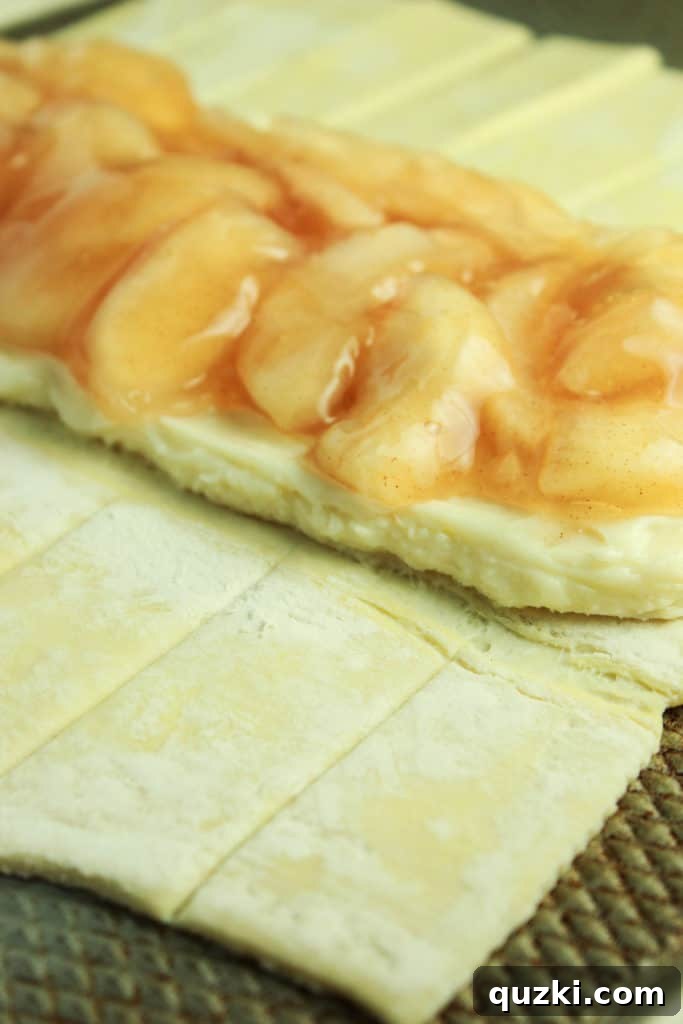 Sweet Apple Cream Cheese Braid 3 Unbaked puff pastry with apple and cream cheese filling, prepared for braiding.