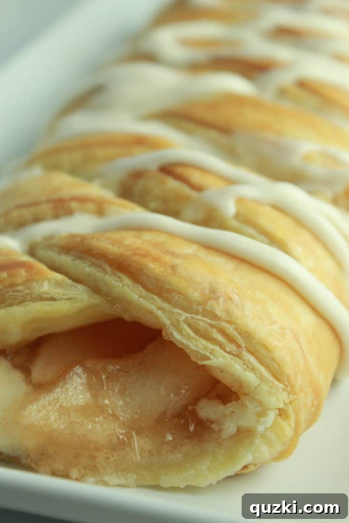 Sweet Apple Cream Cheese Braid 6 Puff pastry braid nearing completion, with the filling fully enclosed by woven strips.