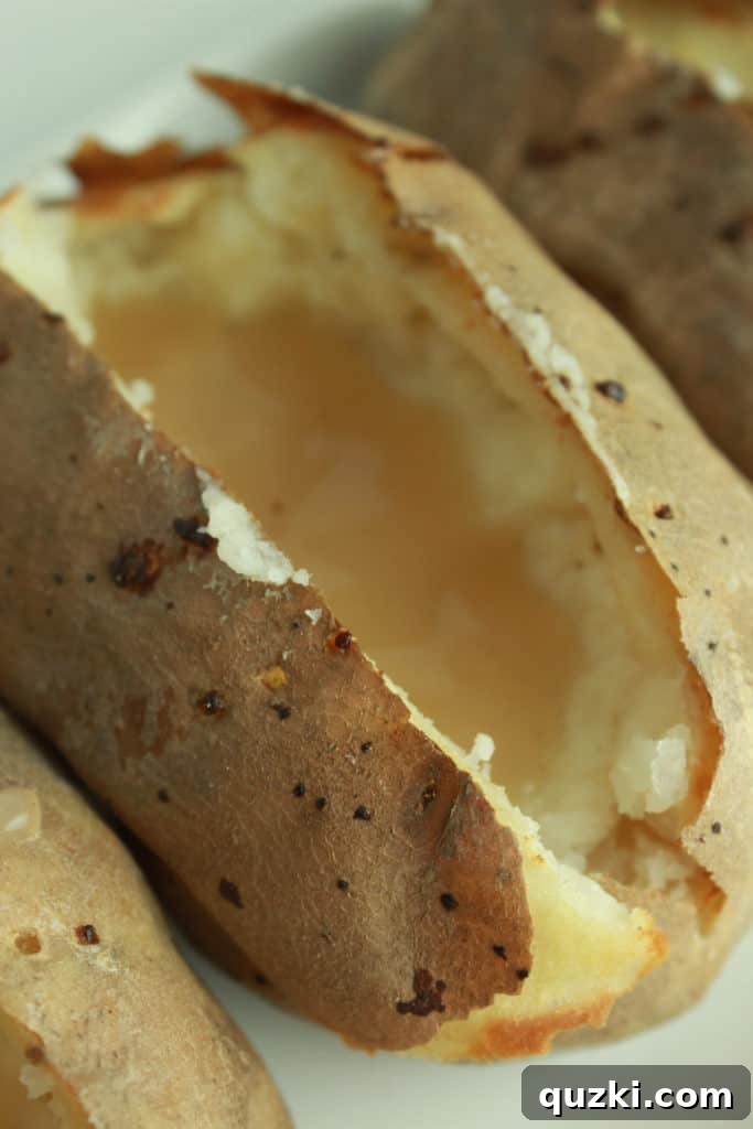 Layering gravy into the hollowed baked potato base
