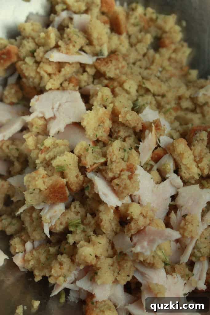 Filling the baked potato with a mixture of leftover turkey and stuffing