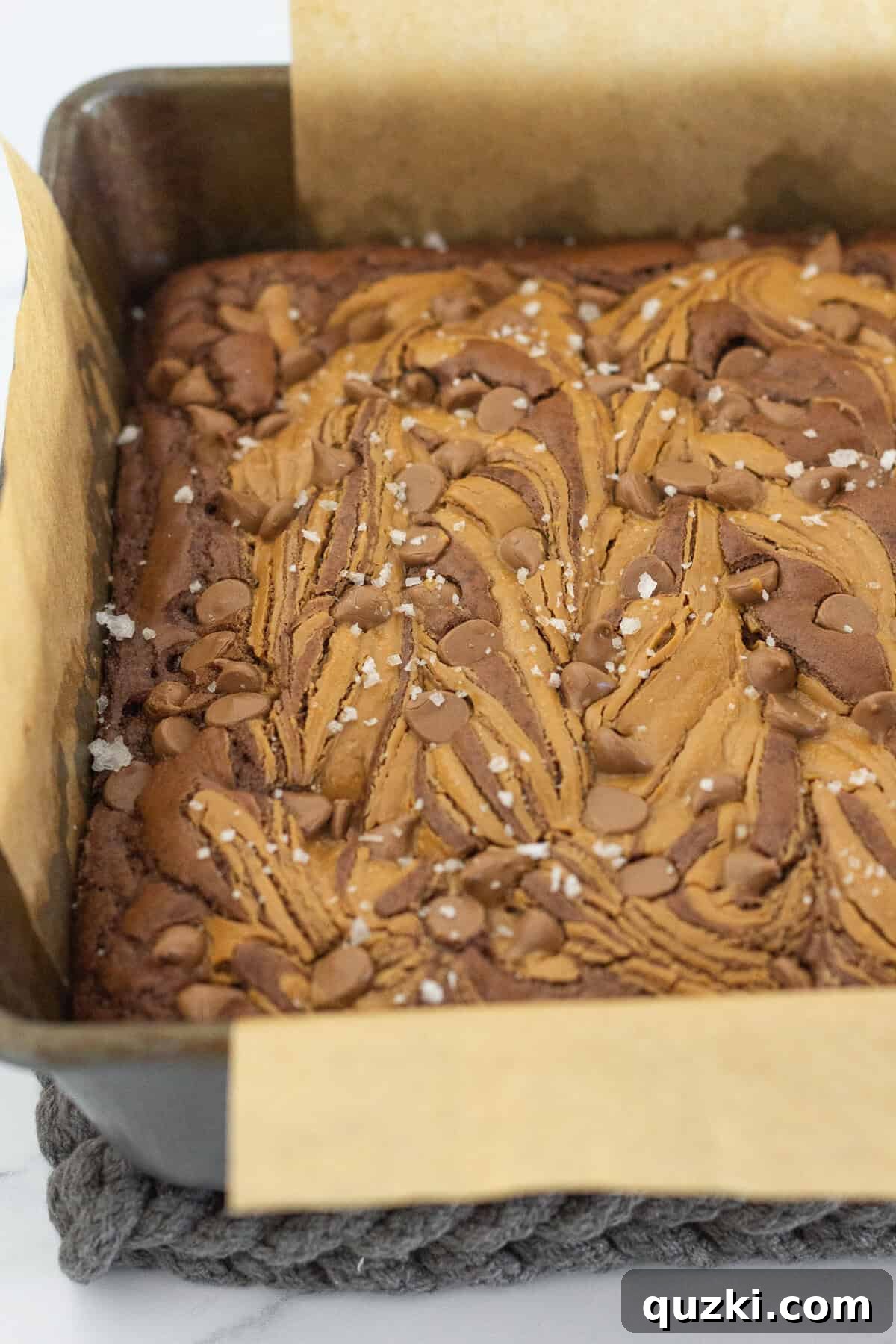 Fudgy Biscoff Cookie Butter Swirl Brownies 11 Removing the brownies from the oven and sprinkling with flaky sea salt.