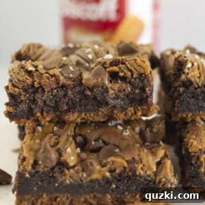 Biscoff Brownies stacked on each other with a cookie crust.