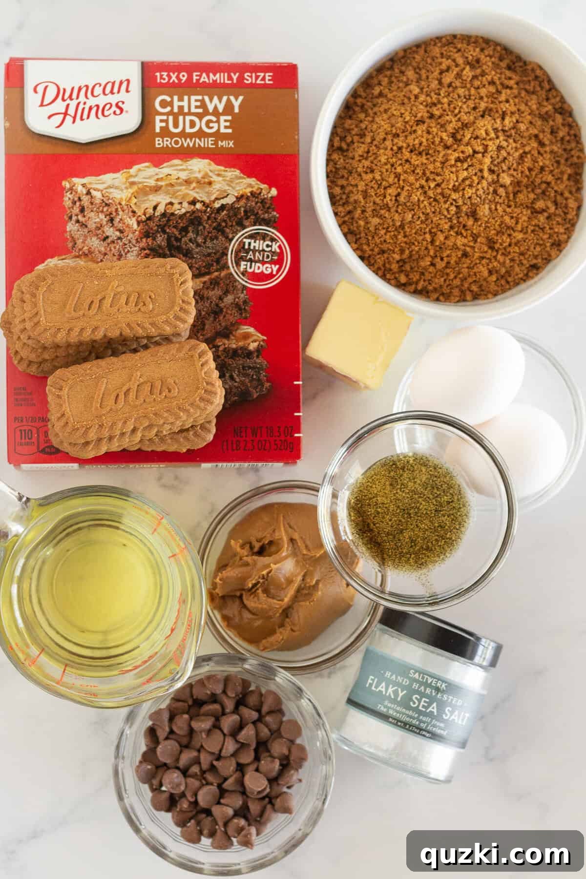 Fudgy Biscoff Cookie Butter Swirl Brownies 3 The array of simple ingredients required to make Biscoff Brownies, including cookie mix, Biscoff cookies, and cookie butter.