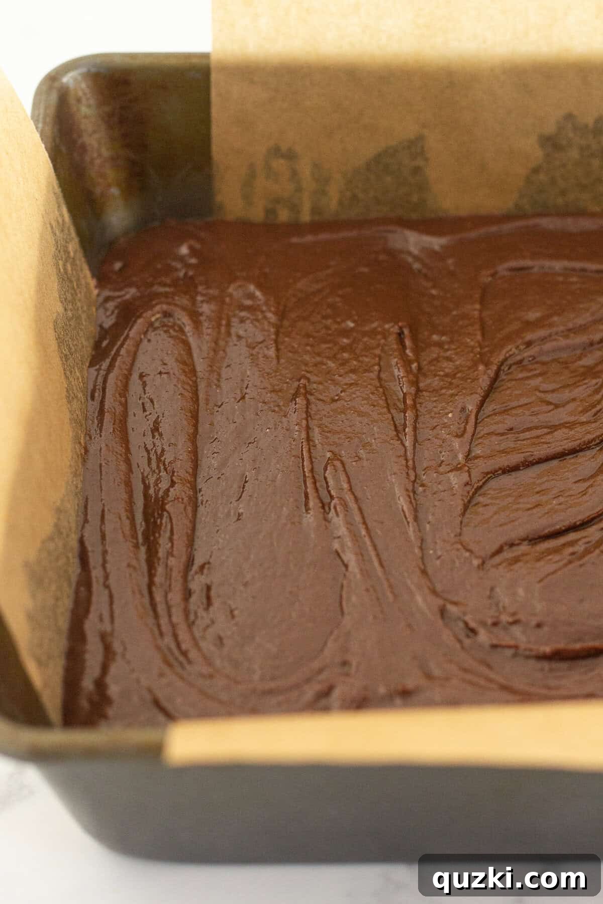 Fudgy Biscoff Cookie Butter Swirl Brownies 7 Pouring the brownie mixture evenly over the Biscoff cookie crust.