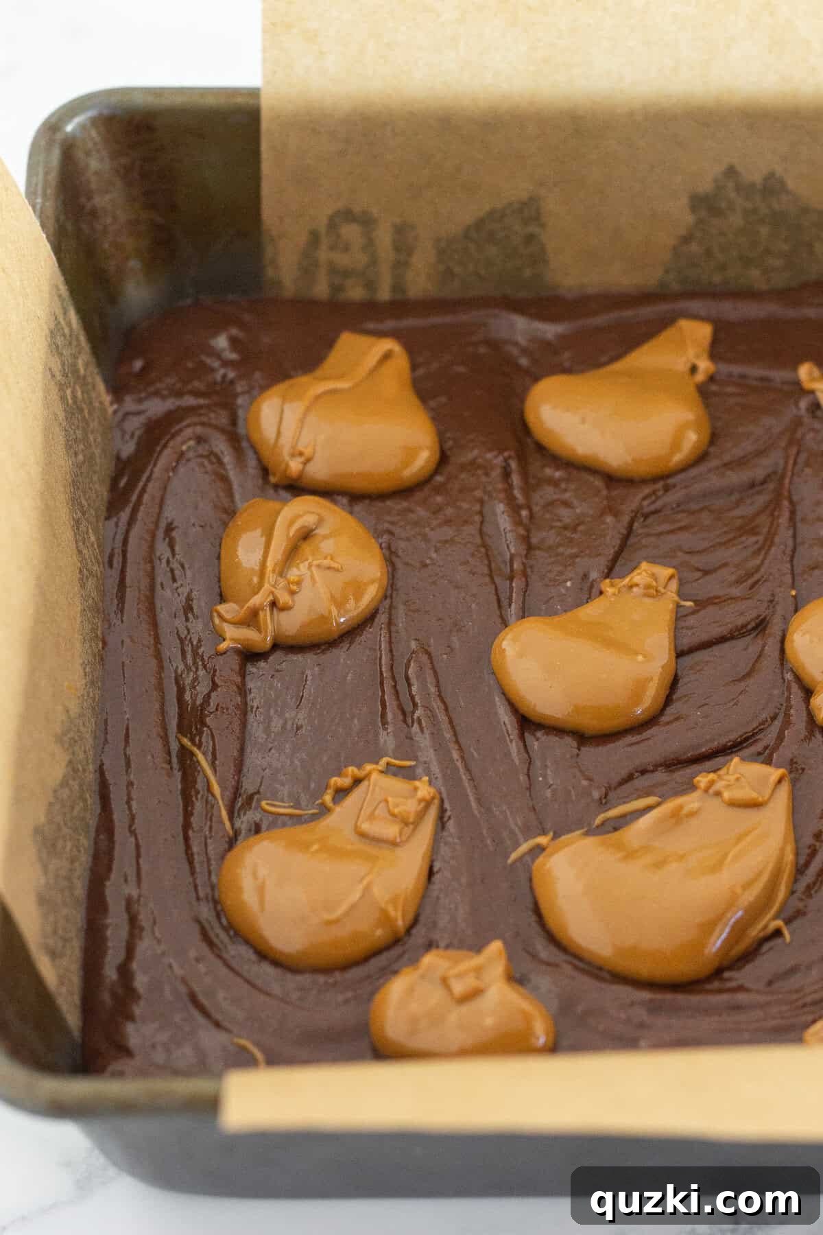 Fudgy Biscoff Cookie Butter Swirl Brownies 8 Adding spoonfuls of warmed cookie butter to the top of the brownie layer.