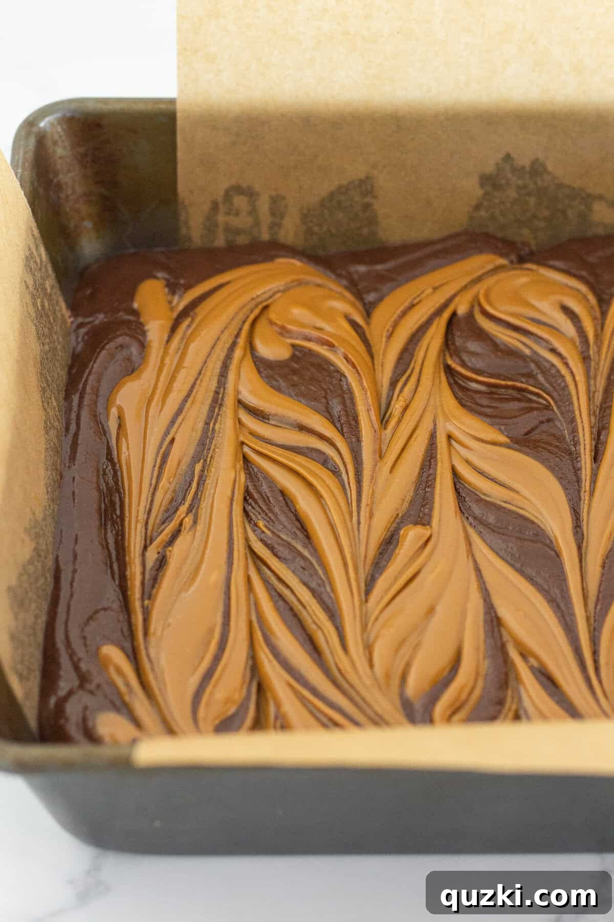 Fudgy Biscoff Cookie Butter Swirl Brownies 9 Swirling the cookie butter into the brownie batter layer using a butter knife.