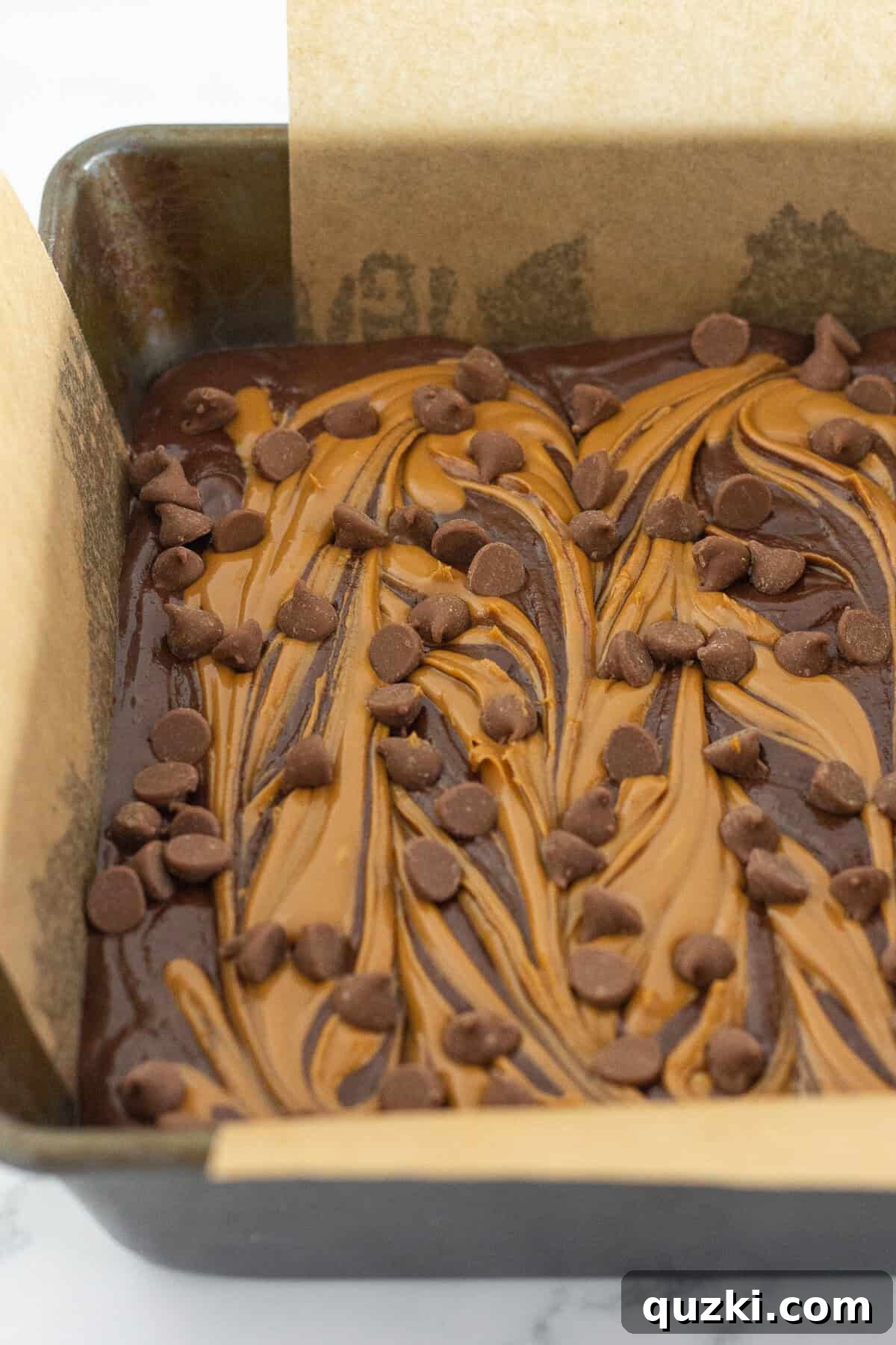 Fudgy Biscoff Cookie Butter Swirl Brownies 10 Topping the brownies with milk chocolate chips and baking for 25-28 minutes.