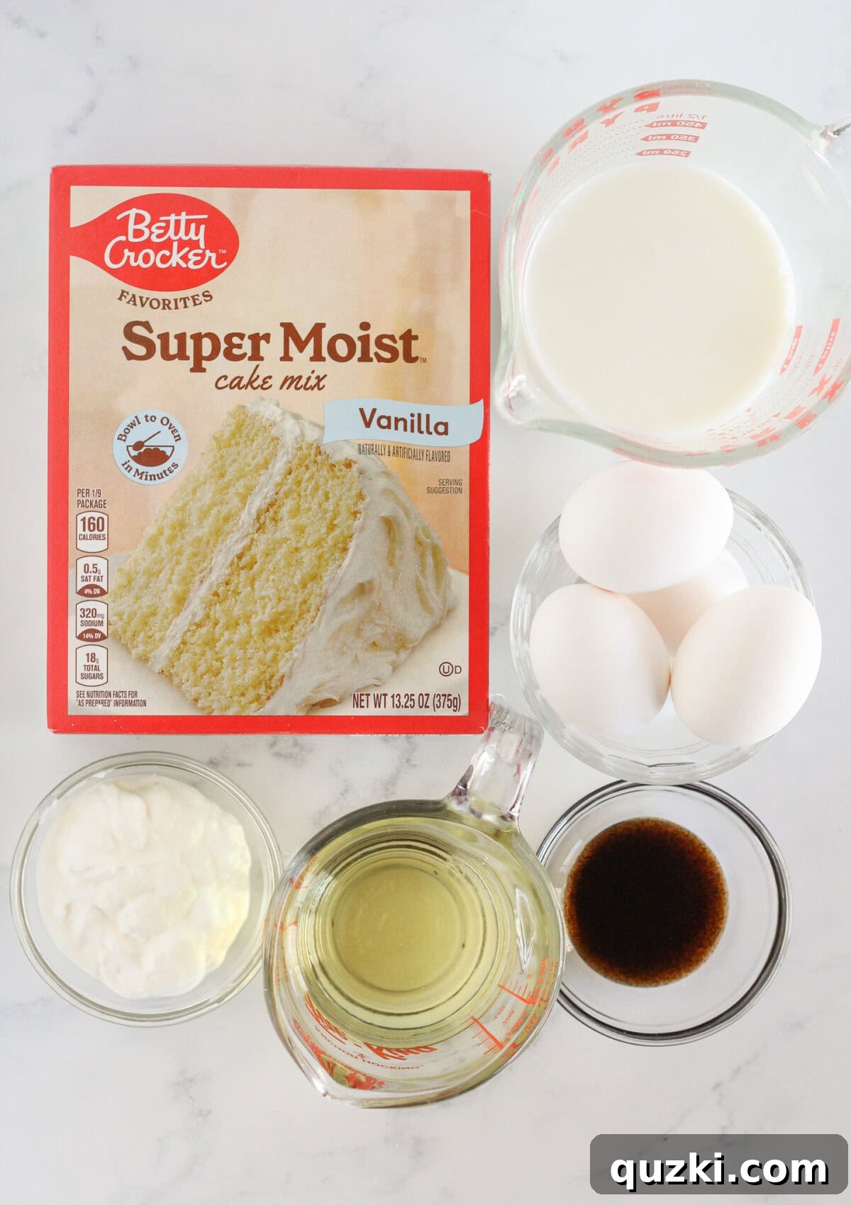 Perfect Vanilla Sheet Cake 3 The essential ingredients laid out to make a homemade vanilla sheet cake using a cake mix.