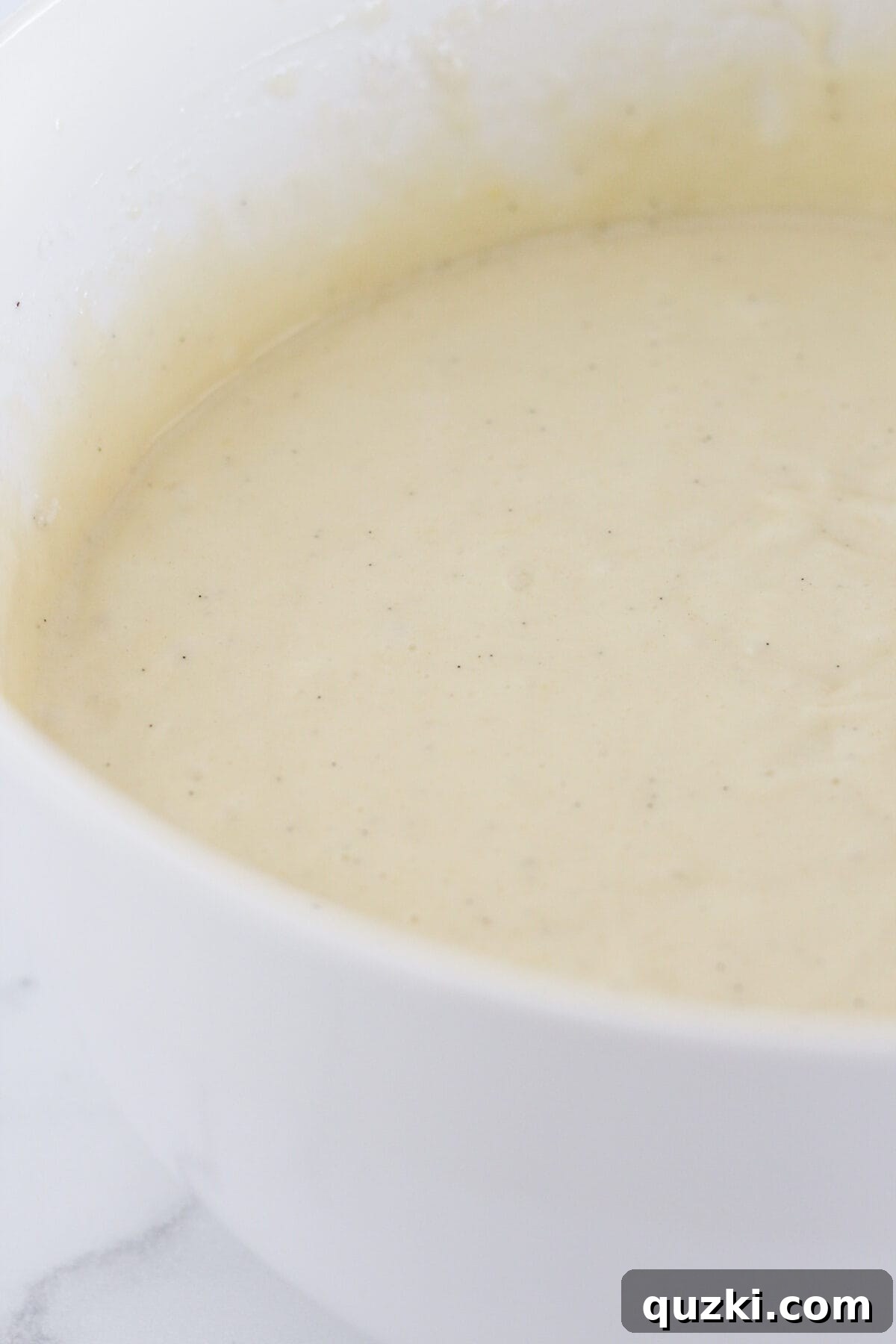 Perfect Vanilla Sheet Cake 4 Making the vanilla sheet cake batter from a cake mix in a large mixing bowl.